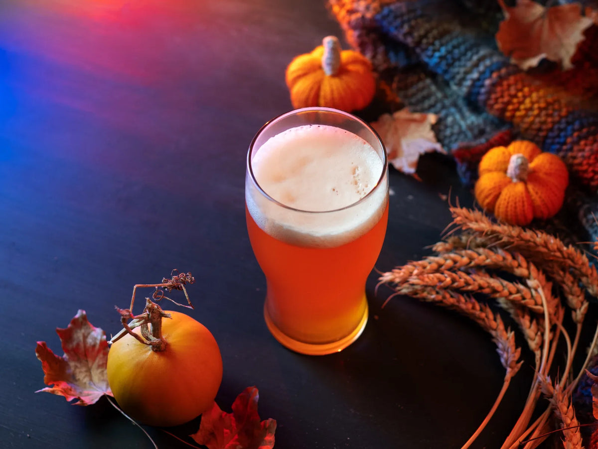 Pumpkin beer with fresh pumpkin, hops, wheat, and autumn leaves