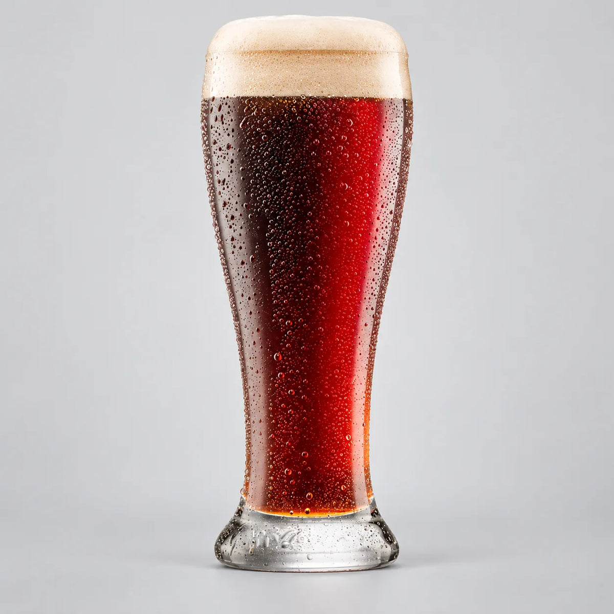 Glass of Coopers Dark Ale with a deep mahogany color and creamy foam head