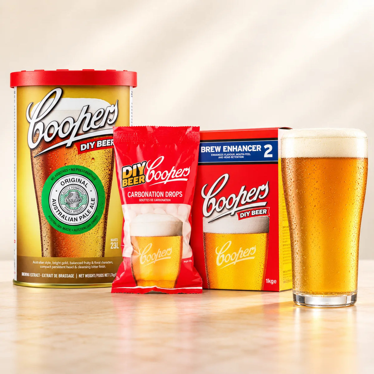 Coopers DIY Australian Pale Ale 5 Gallon Refill with beer glass, carbonation drops, and Brew Enhancer 2