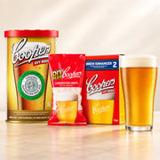 Coopers DIY Australian Pale Ale 5 Gallon Refill with beer glass, carbonation drops, and Brew Enhancer 2