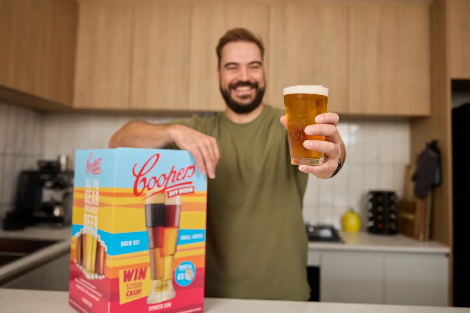 Homebrewer holding a glass of Coopers beer