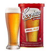 Coopers Real Ale Brewing Extract can with a glass of bright golden traditional ale