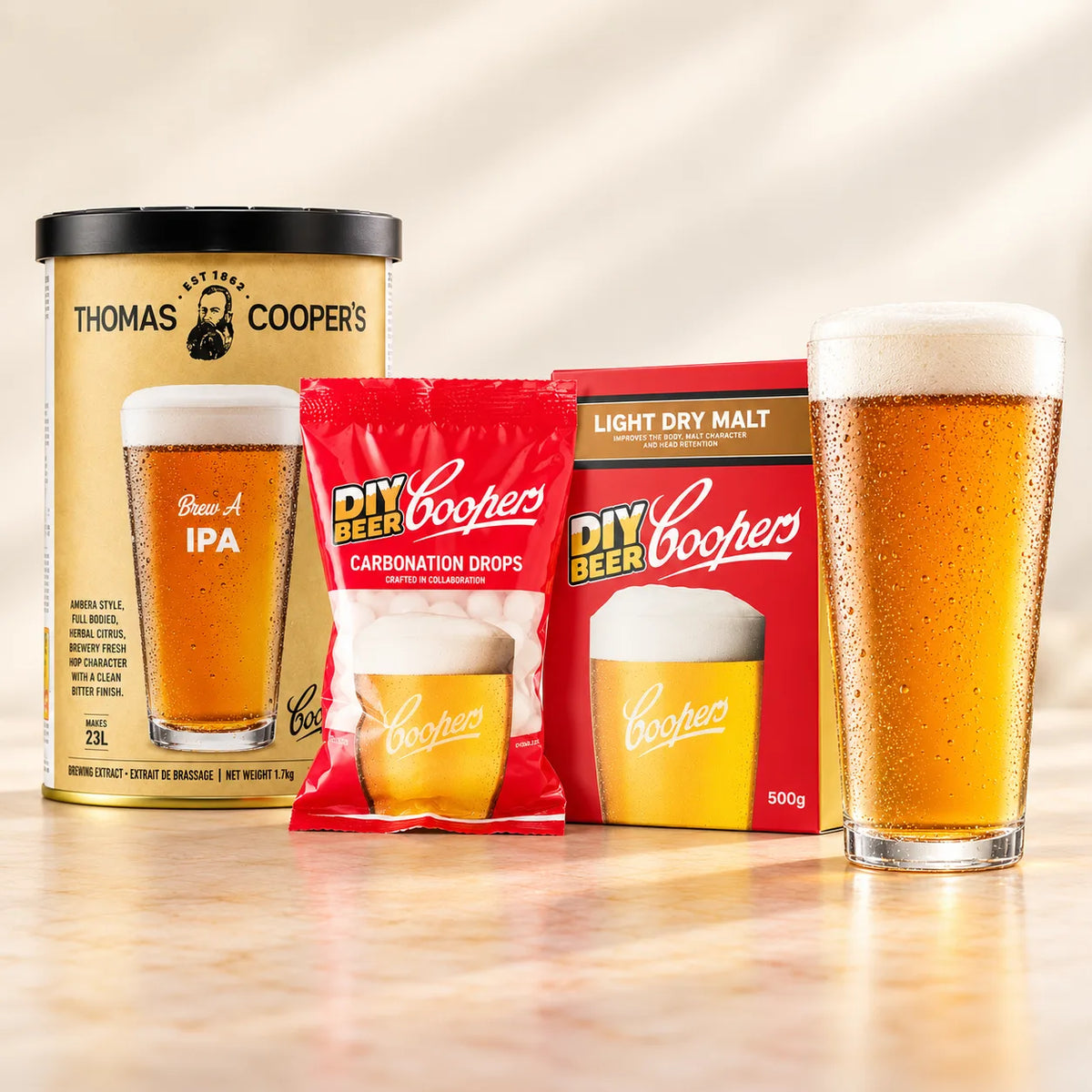 Thomas Coopers Brew A IPA refill with light dry malt, carbonation drops, and a glass of amber IPA.
