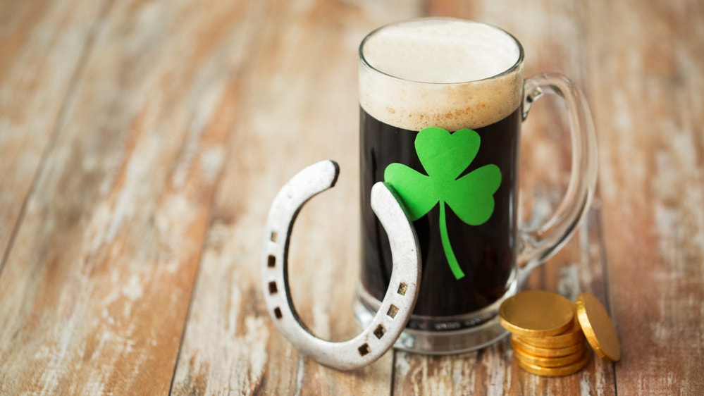 A cozy brewing setup featuring Mr. Beer’s fermenter and ingredients for the Irish Cream Porter, perfect for celebrating St. Patrick's Day.